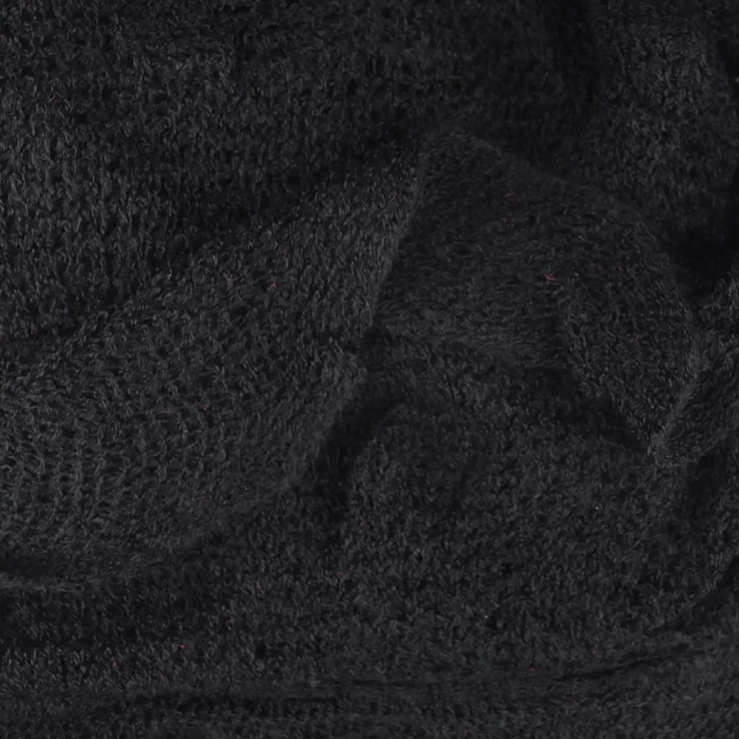 Lightweight knitted ruffled scarf in black with white background