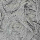 Lightweight knitted ruffled scarf close up.