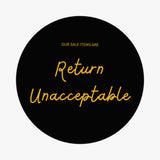 Circular black sign with yellow text stating Our sale items are Return Unacceptable includes damaged fabric