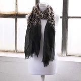 Leopard print and black ombre scarf draped on mannequin, includes damaged fabric details