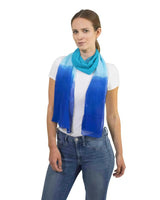 Woman wearing a white shirt and blue jeans with a plain chiffon scarf in blue ombre