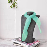 Chiffon square scarf in aqua on grey chair