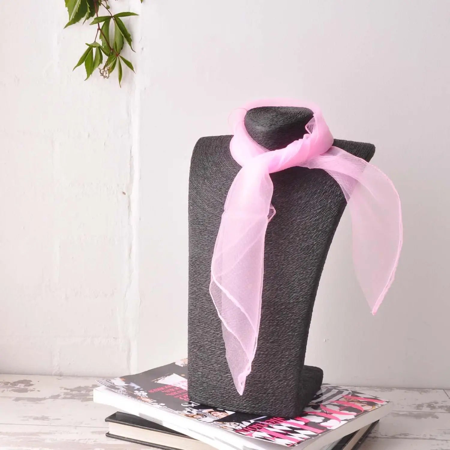 Baby pink chiffon square scarf displayed on black mannequin