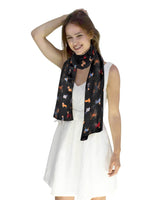 Woman wearing a black satin stripe dog print scarf.