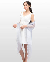 Woman in white dress and sandals with Sheer Shimmer Evening Lightweight Stole