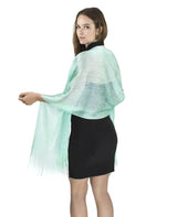 Woman wearing a green shimmering lurex fishnet evening shawl.