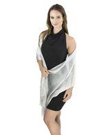 Woman wearing a black and white shimmering lurex fishnet shawl