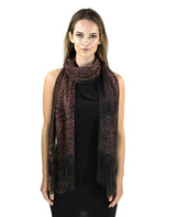 Shimmering lurex fishnet scarf worn by woman in black top and pink scarf.