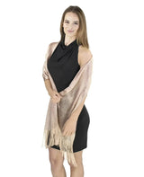 Shimmering lurex fishnet evening shawl worn by woman in black dress