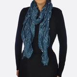 Shimmering metallic textured blue scarf on woman