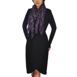 Woman wearing a purple shimmering metallic textured scarf.