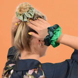 Woman with green bow on head wearing Shimmering Soft Satin Hair Scrunchies