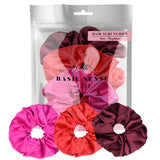 Shimmering soft satin hair scrunchies in pink, red, and purple