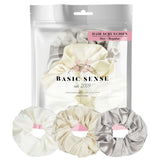 Shimmering soft satin hair scrunchies with pink ribbon.