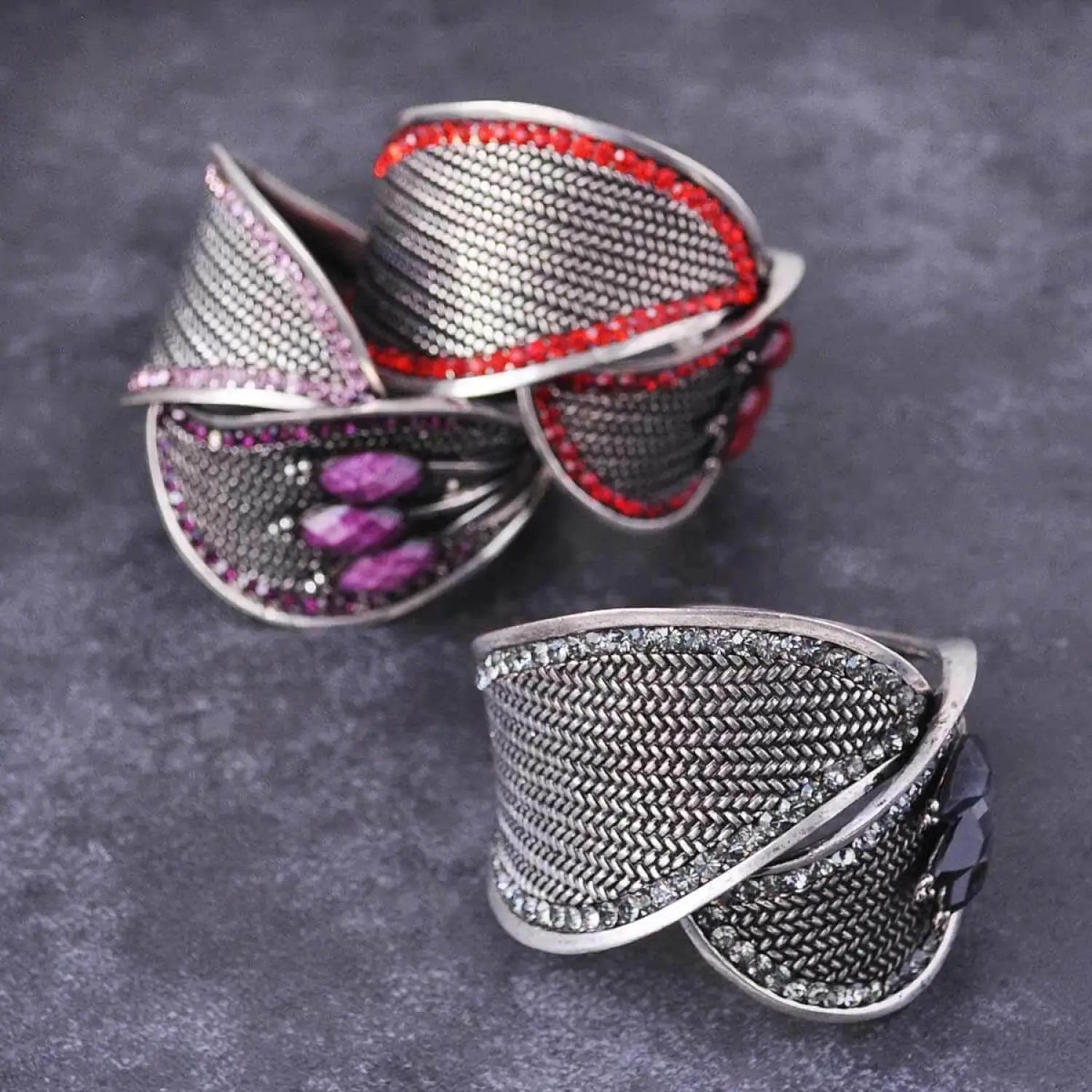 Silver bangle bracelet with pink and red stone rings