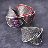 Silver bangle bracelet with pink and red stone rings