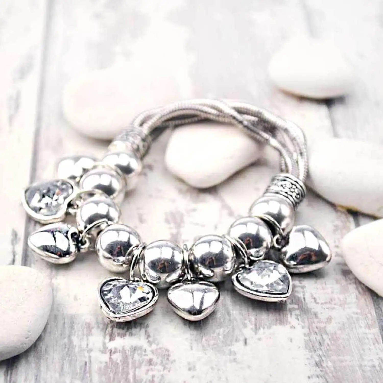 Silver elasticated bracelet with rhinestone heart charm, statement chunky accessory