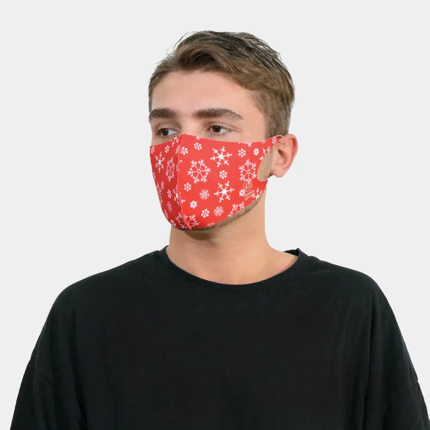 Young man wearing red face mask with snowflakes, copper ion infused for protection.