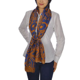 Woman wearing blue and orange Aztec print oversized pashmina scarf.