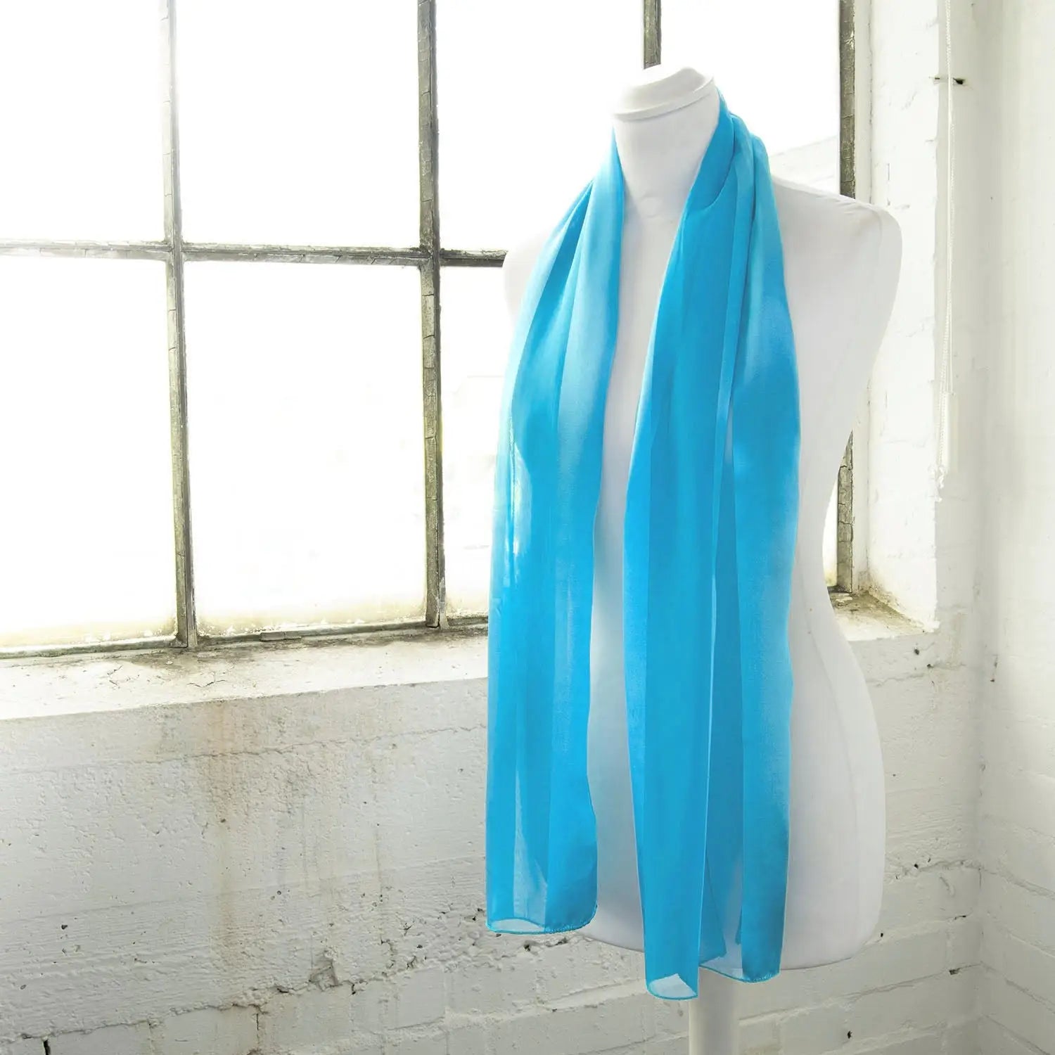 Blue satin stripe scarf elegantly displayed on white mannequin