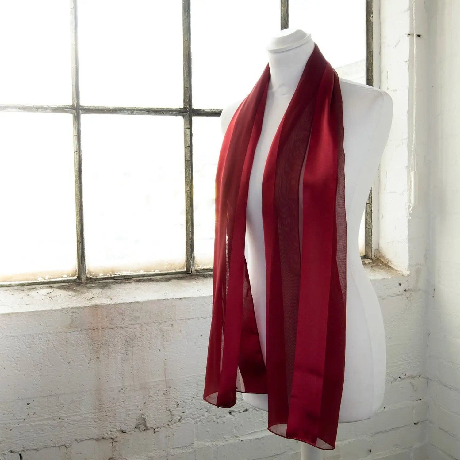 Solid Shimmering Satin Stripe Scarf - Lightweight displayed on mannequin in front of window