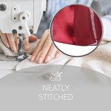 Woman using sewing machine to make red satin stripe scarf