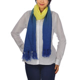 Sophisticated embroidered dip dye tassel scarf in blue and yellow worn by woman