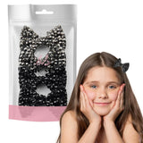 Girl wearing black and pink bow rhinestone hair clips.