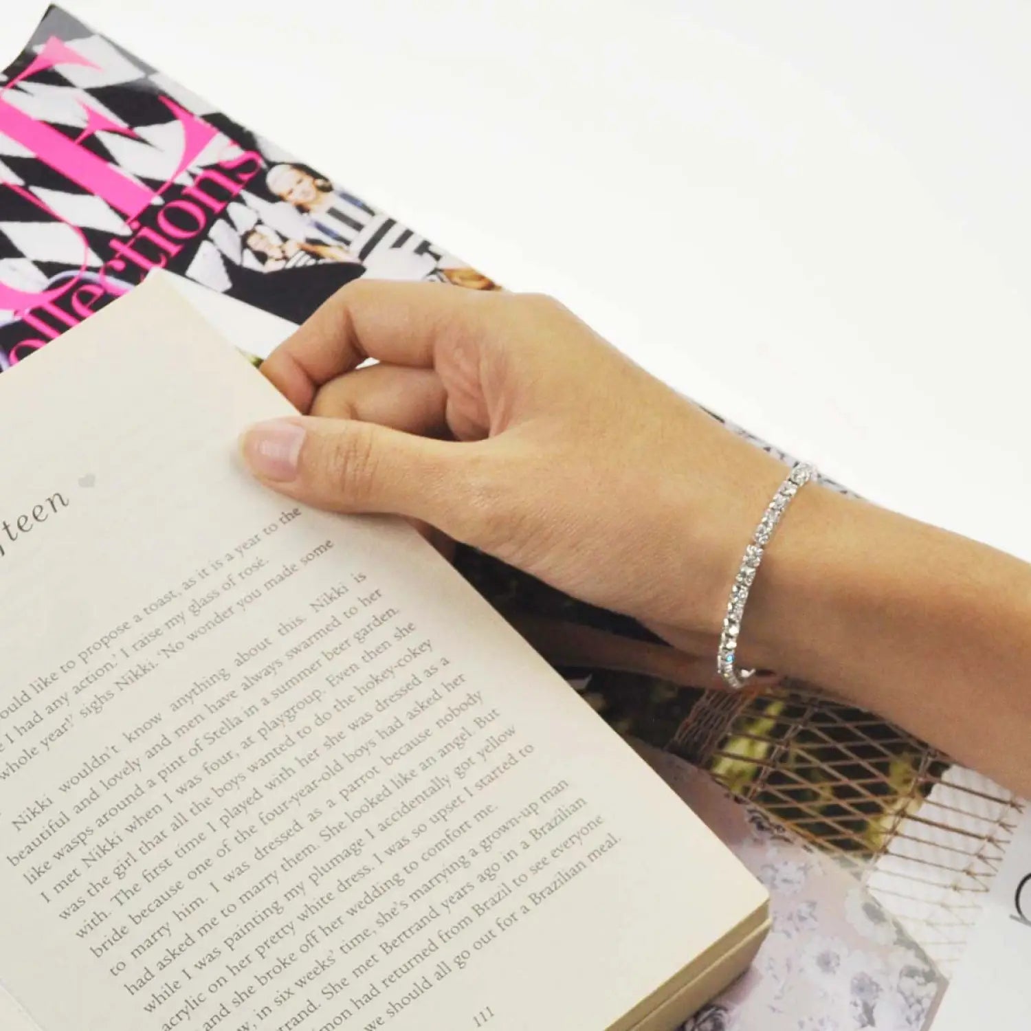 Person holding pink book on Sparkling Stone Cuff - Crystal Diamante Bracelet.