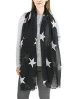 A woman wearing a black scarf with white stars from Star Oversized Scarf Shawl for All Seasons.