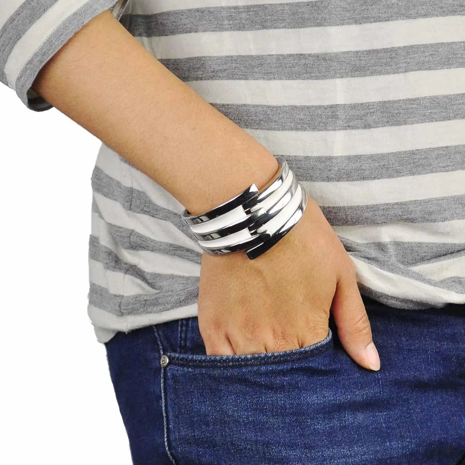 Striped metal hinged bangle on man’s wrist