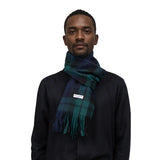 Tartan Winter Scarf in blue and green tones wrapped around a person’s neck for warmth