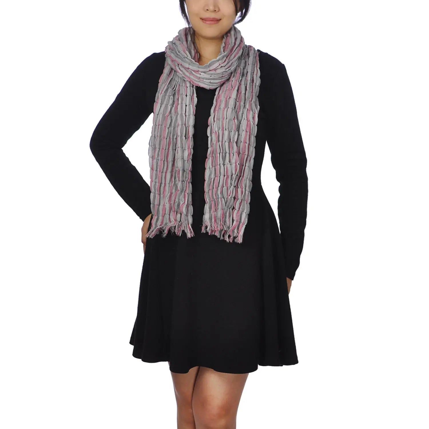 Woman wearing textured check print scarf and black dress.
