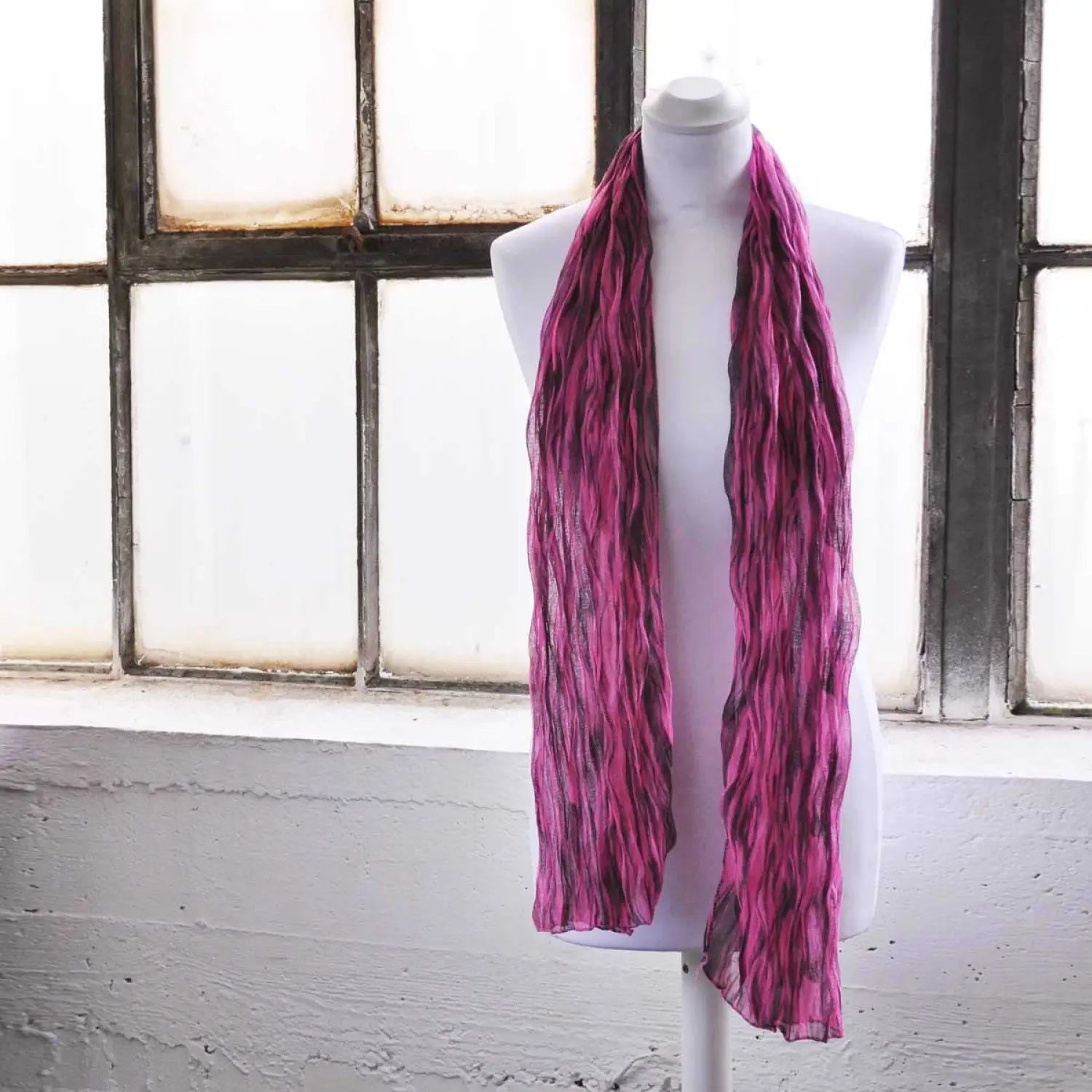 Close up of mannequin wearing pink tie dye crinkled scarf