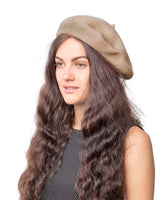 Woman with long brown hair wearing a French wool beret