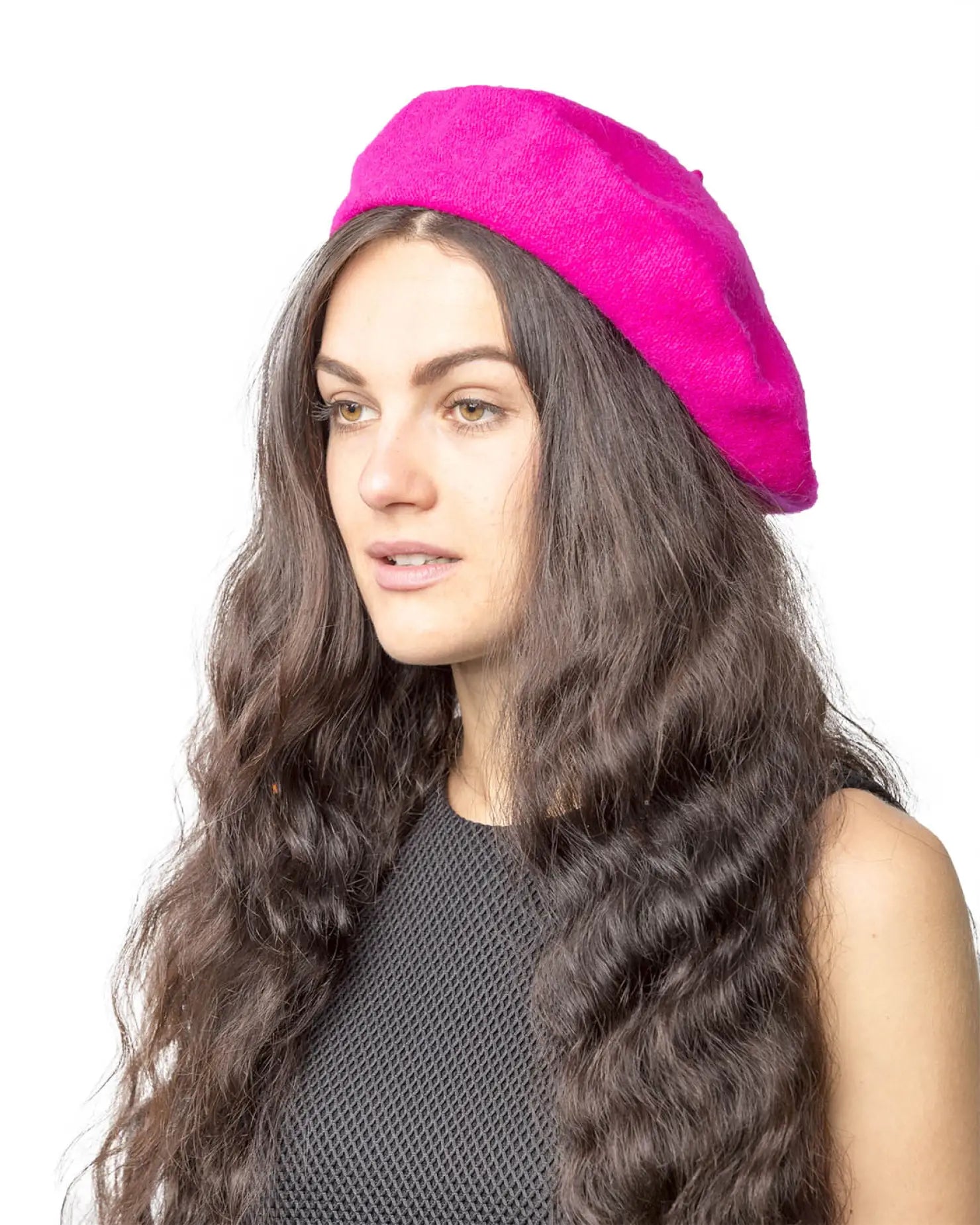 Stylish woman in pink hat with long hair, French wool beret.
