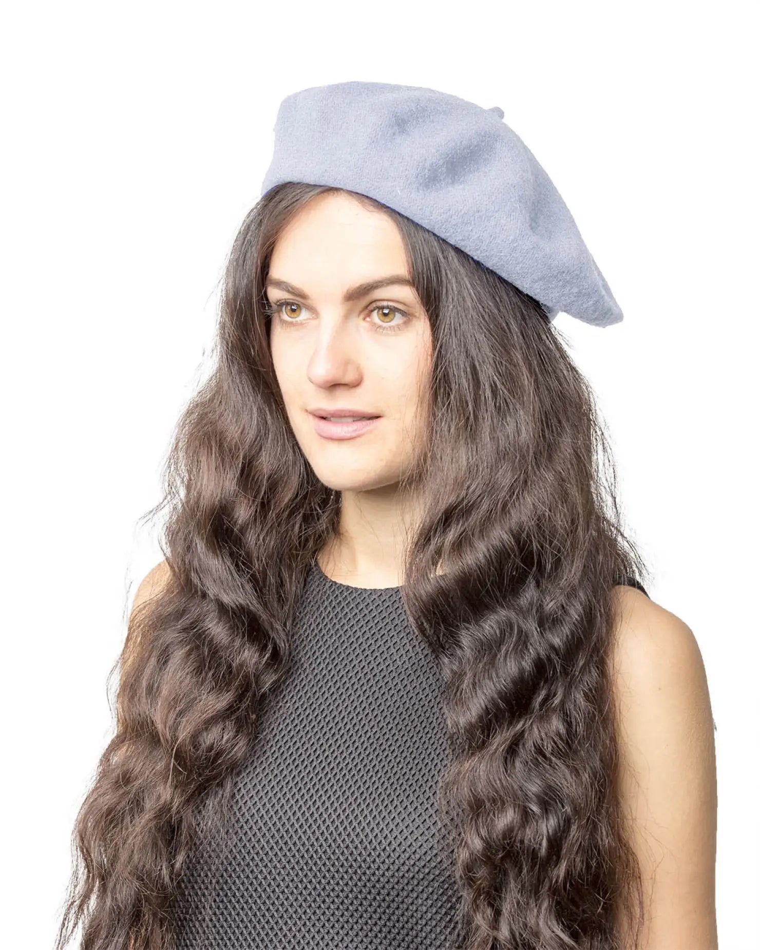 French wool beret in elegant blue worn by woman with long brown hair