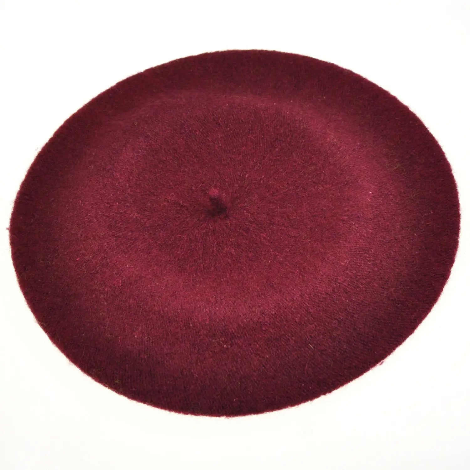 Red French wool beret on white background