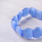 Blue pastel plastic bead bracelet with small bead on elastic band