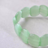 Pastel plastic bead elastic bracelet with small green bead