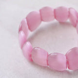 Pink jade bracelet on pastel plastic bead elastic bracelet.