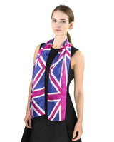 Chic woman showcasing a silk scarf featuring a bold Union Jack print in pink and blue, a statement piece.