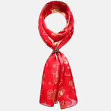 Red and white patterned gingerbread man satin scarf showcased in holder set.