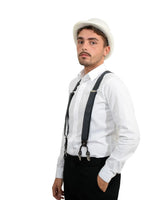 Stylish man wearing white shirt and suspenders with classic wool felt bowler hat