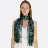 Woman wearing green and black Scottish check wrap scarf