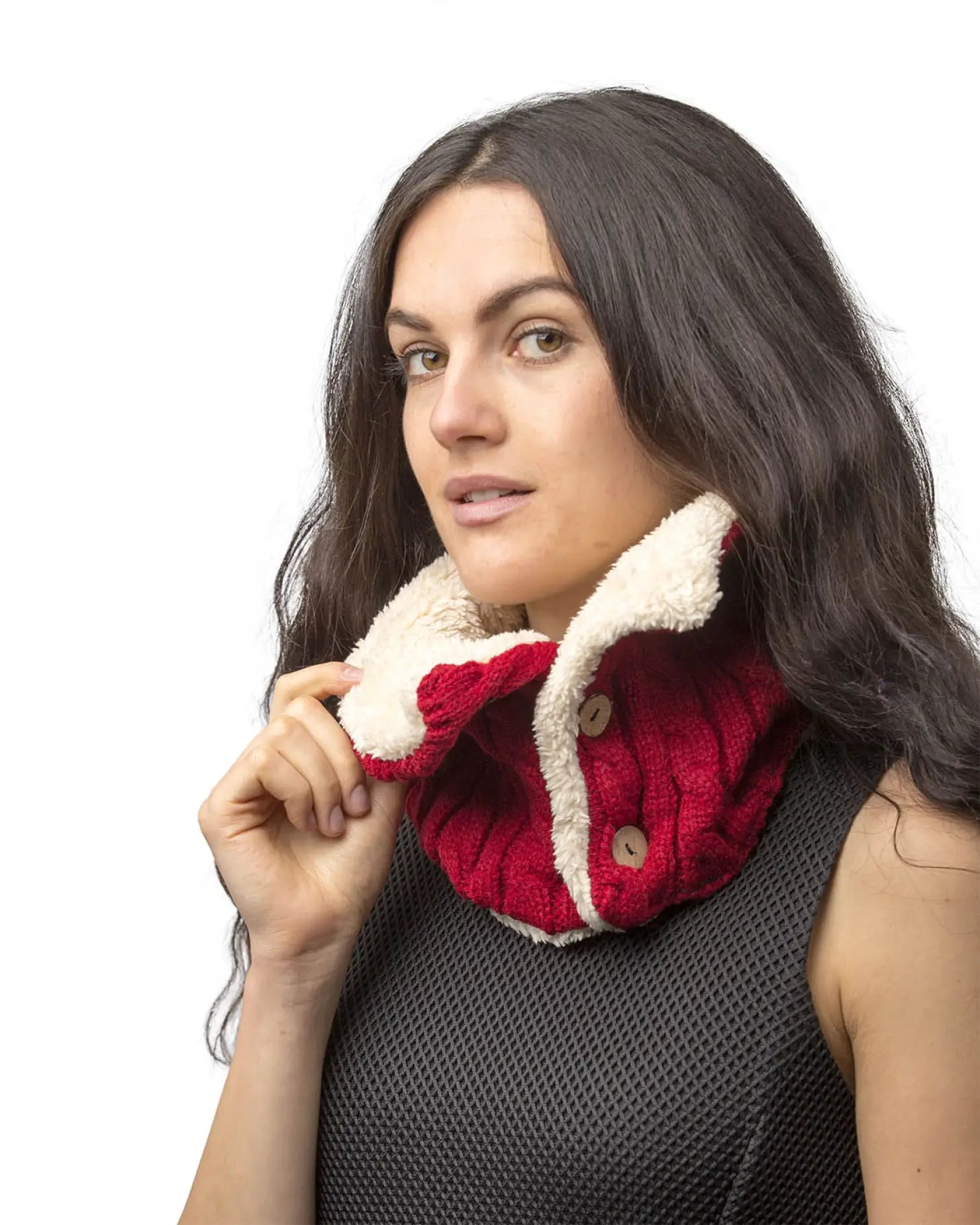Woman wearing red and white knitted buttoned snood scarf.