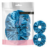 Large velvet hair scrunchies and hair ties in premium packaging.