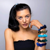 Woman in black top with blue bracelet wearing Velvet Skinny Hair Scrunchies Set for versatile styling.