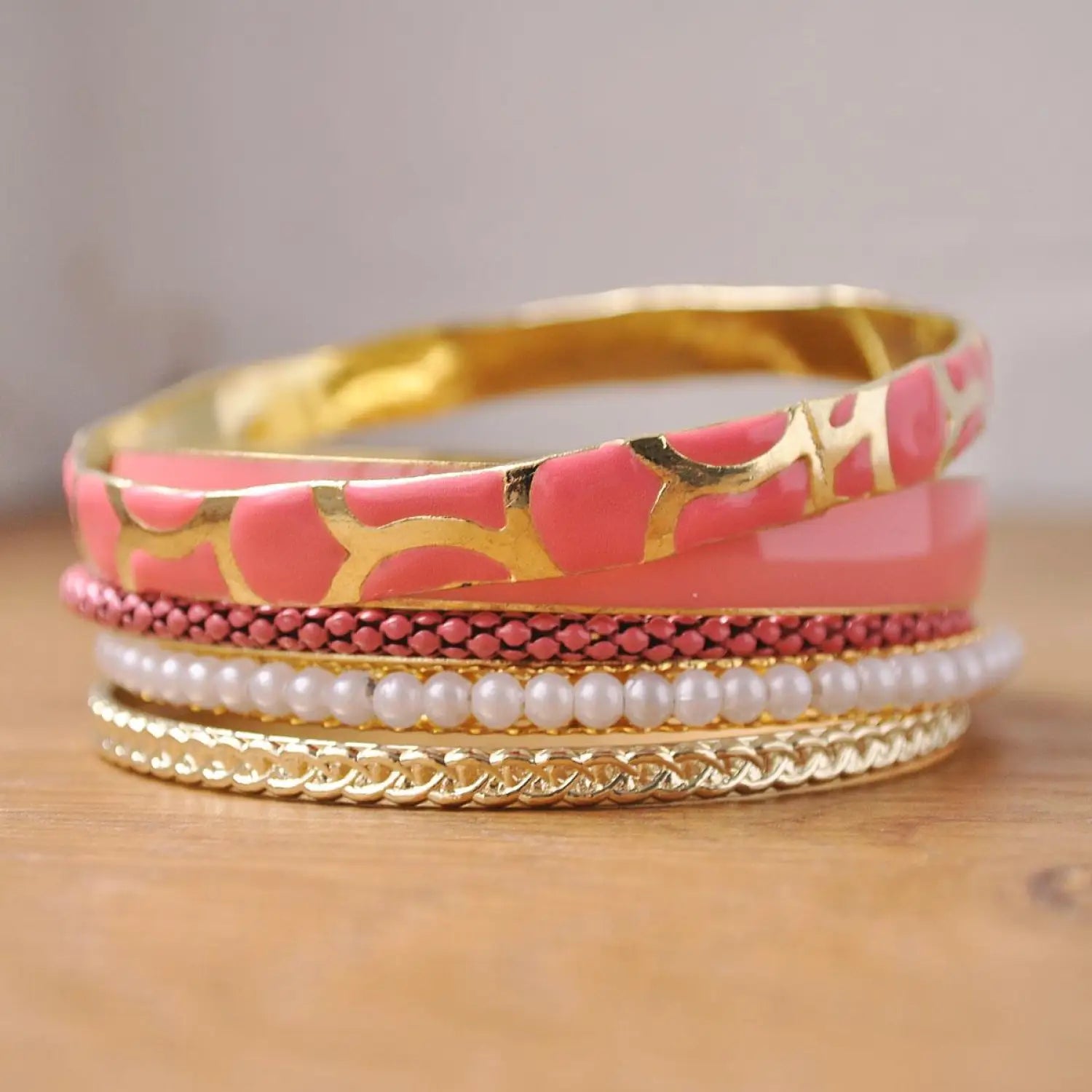 Pink and gold metal stackable bangles for Indian wedding - product display.