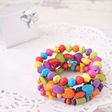 Colorful polymer bead bracelet with wood-effect plastic beads, vibrant multi coloured design.